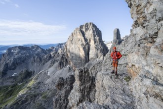 Mountaineer climbs an exposed rock band in the secured Via Ferrata Bocciere Centrale via ferrata,