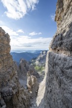 View from the Bocca degli Armi gap, mountaineers on a rock band on the Via Ferrata Bocciere