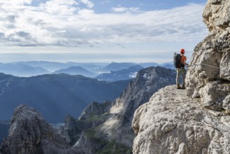 Two mountaineers climb an exposed rock band in the secured Via Ferrata Bocciere Centrale via