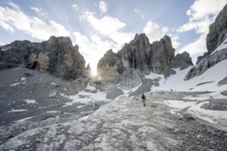 Ascent in a rocky mountain landscape with steep rocky peaks to Bocca degli Armi, Sun Star, Brenta