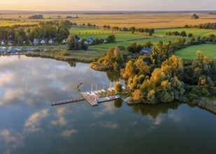 Drone view of Dümmer See with boats in a sailing harbor, surrounded by landscape with fields and