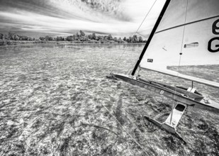Ice sailors on water in black and white with strong contrast and structure, Dümmer nature park