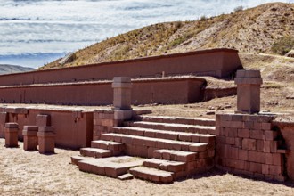 Historic ruins with stairs in a desert landscape under clear skies, The archaeological site with