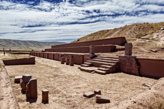 Ancient ruins and stone structures in a vast landscape under a cloudy sky, The archaeological site