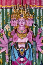 Colourful depiction of a multi-headed deity with detailed decorations, the Seema Malaka temple with