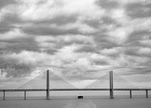 Dramatic clouds in the sky over the Öresund Bridge between Malmö and Copenhagen, painted in black