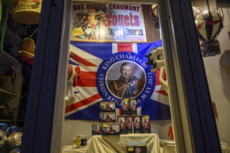 Street scene in the old town of Naantali, A decorated shop window with flag and King Charles II