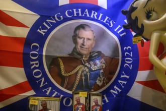 Street scene in the old town of Naantali, colorful flag with portrait of King Charles III and