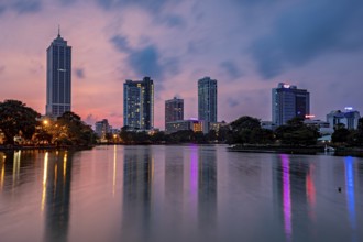 City view at dusk with illuminated skyscrapers and colorful reflections in the river, the skyline