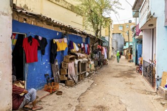 Alley with colorful walls and hung clothes in an urban setting, people in the streets of Slave