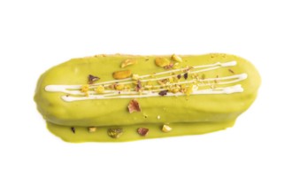 Glazed green Eclair on brown concrete isolated on white, top view, flat lay, close up