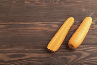 Orange Carrot on brown wooden background. Side view, copy space. healthy food, vegetable,