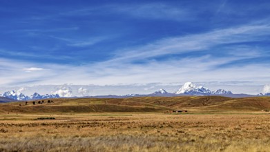 Wide hilly landscape with mountains and a cloudy sky, The Altiplano landscape in the Andes of