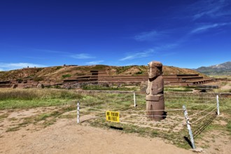 Stone statue in a ruined landscape with a prohibition sign in the foreground, The archaeological