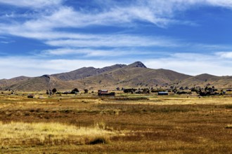 Wide fields and hills under a clear blue sky, The Altiplano landscape in the Andes of Bolivia