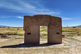 Monumental stone gate on a wide area with blue sky in the background, The archaeological site with