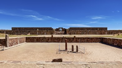 Open ruins with stone walls and sandy soil under a clear blue sky, The archaeological site with the