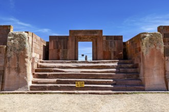 Stone architecture with stairs and entrance surrounded by ruins under blue skies, The