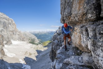 Mountaineers on a narrow band of rocks on the Via Ferrata Bocciere Centrale via ferrata,