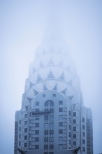 The Crysler Building tower in fog, New York, USA