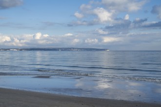 View across the Baltic Sea towards chalk coast, beach, sky with white clouds, Binz, seaside resort,