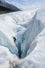 Ice climbers in an ice canyon, Root Glacier, Wrangell St. Elias National Park, Alaska, USA
