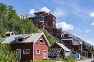 Red Kennicott buildings in front of mountainous landscape, Kennicott Concentration Mill to extract