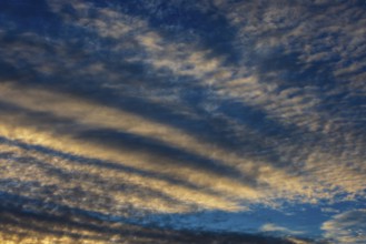 Dramatic cloudy sky, cirrus clouds at sunset, plume clouds, Austria