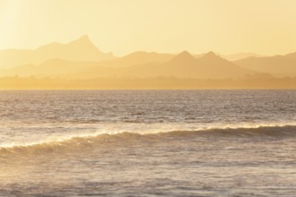 Evening light at Cape Byron with view to Mount Warning and sunlit hinterland, New South Wales,