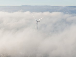 Blurred wind turbine hiding in thick clouds covered in fog, Bad Wildbad, Calw district, Black