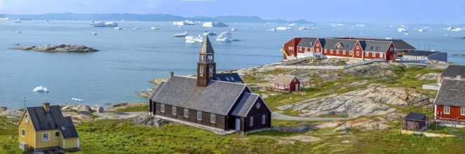 Typical architecture of Greenland Ilulissat with colored houses located near fjords and icebergs