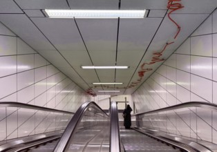 Artwork titled Spur X by Enne Hähnle, escalators of the Kirchplatz subway station, Werhahm line,