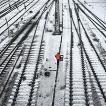 Railway workers between many tracks in winter, train formation in the Vorhalle district,