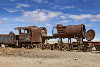 Rusty locomotive shows clear damage in an abandoned desert landscape, old rusty locomotives at the