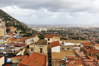 View of red tile roofs of the city of Monreale, Palermo on the horizon, Monreale, Sicily, southern