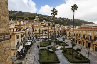 View of green areas, tall palm trees and fountains, Piazza Vittorio Emanuele, City Hall, Monreale,