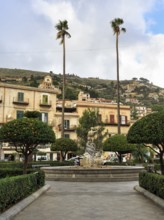 Tall palm trees, central fountain, hedges and orange trees, Piazza Vittorio Emanuele, Monreale,