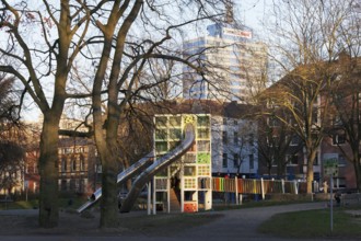Children's playground with colorful climbing tower and slides, Immanuel-Kant-Park, Duisburg, North