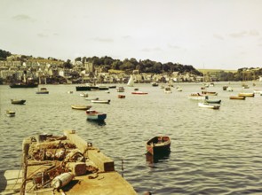 Boats at moorings in harbour of town Fowey, Cornwall, England, UK view across River Fowey estuary