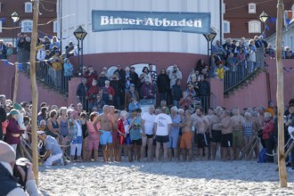 Tourists waiting in front of the spa hotel to bathe, swimmers ready to start in the water, tourist