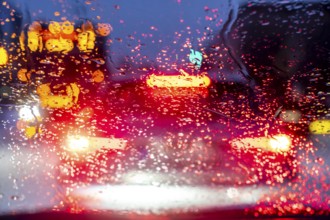 Driving in winter, in snow, rain, rear lights, brake lights