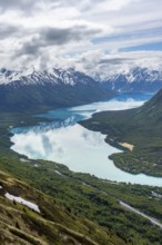 View of snowy mountains in spring and turquoise Kenai Lake with reflection, Slaughter Ridge Trail,