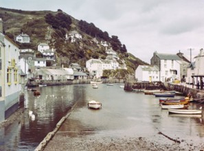 Historic waterfront buildings around the harbour river mouth of the River Pol at village of