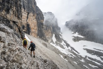 Two mountaineers descending to Rifugio Alimonta, Brenta Mountains, Trentino, Italy