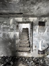 Old Wehrmacht anti-aircraft bunker from the Second World War with worn stairs in a dilapidated,