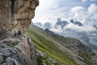 Mountaineers on a trail in front of picturesque mountain landscape with rocky peaks, Via Ferrata