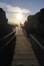 Walkers, tourists on hiking trail, Þingvellir National Park, impressive Almannagja Gorge,