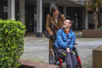 Woman and man with disability smiling outdoors, focusing on happy interaction, personal growth,