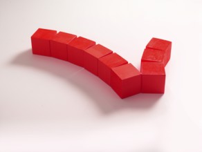 9 red wooden cubes against a white background