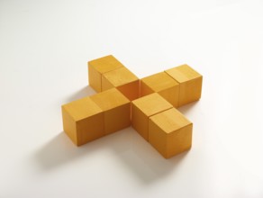 8 yellow wooden cubes against a white background